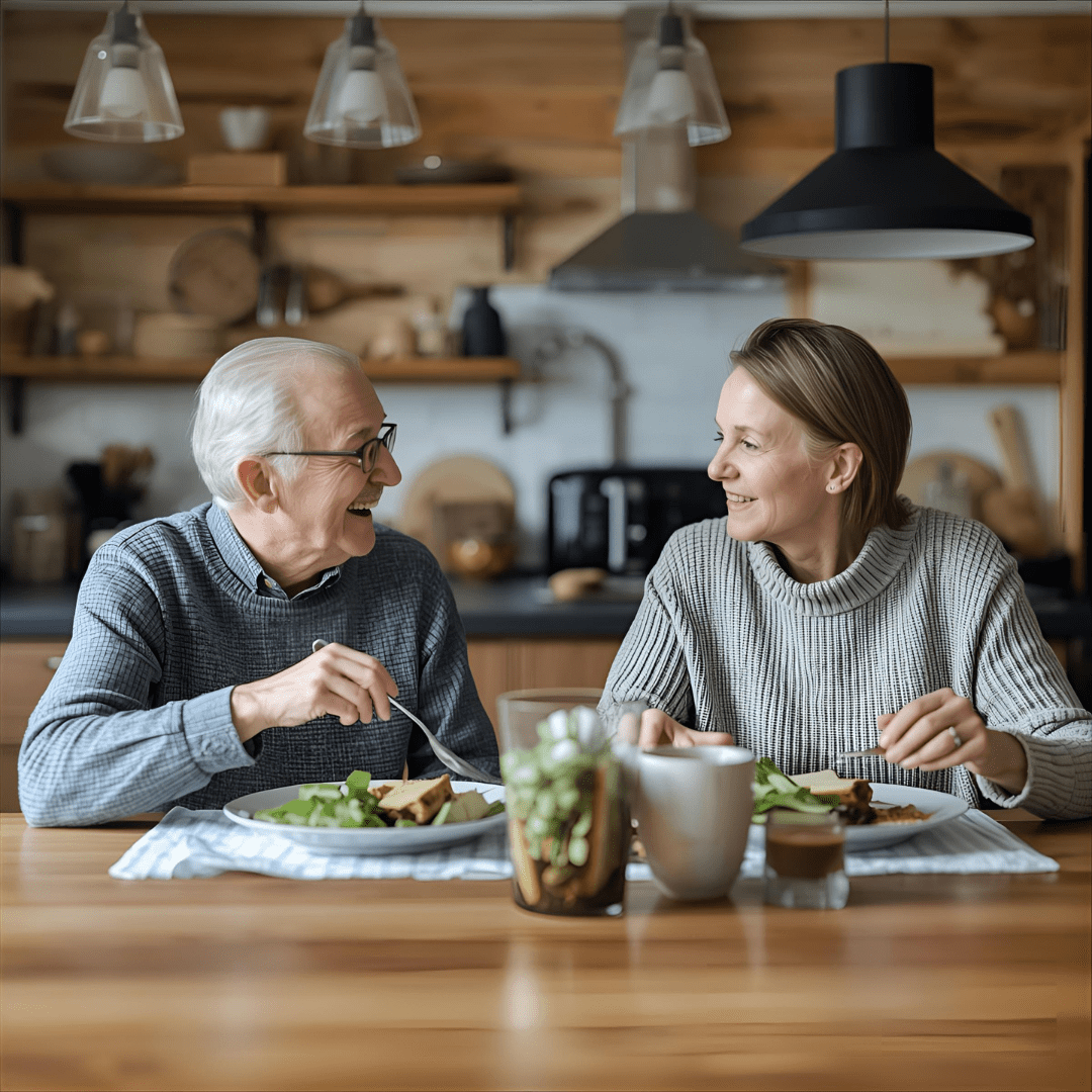 A relaxed senior enjoying a meal at the dining table, smiling and stress-free.
