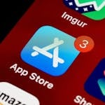 Close-up of App Store icon on iPhone screen with notification badge, highlighting app updates.