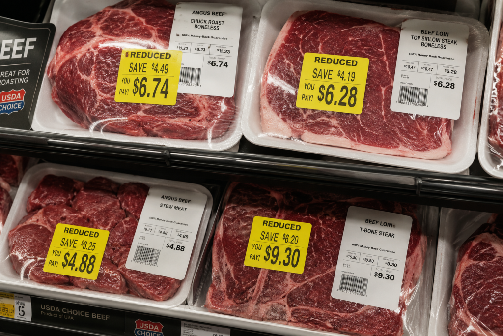 Yellow markdown stickers on reduced price meat packages help save on groceries.